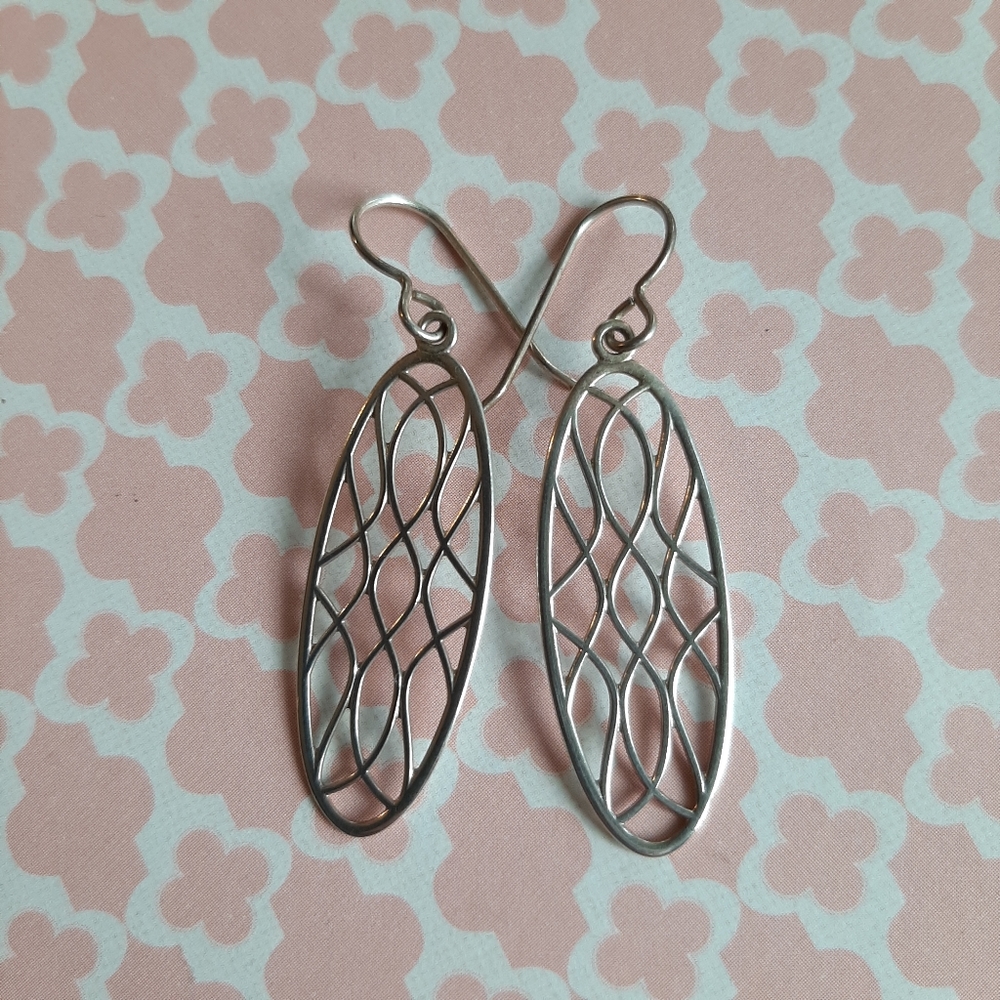 Silver artisan made earrings, intricate oval